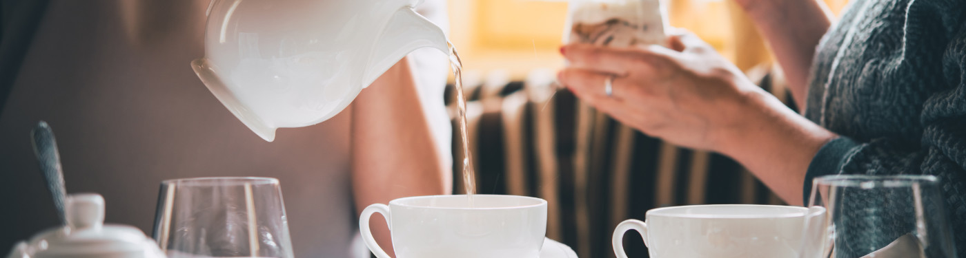 Rebecca Hughes | English Conversation Banner Image | Set table with lady pouring tea