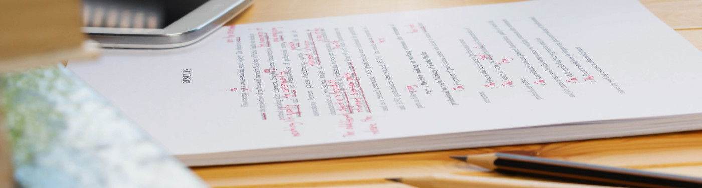 Rebecca Hughes | Proofreading & Translations Banner Image | Marked exam paper on a table